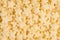 Yellow stars corn flakes closeup background, cereals texture. Top view.