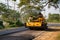 Yellow steamroller or soil compactor working on asphalt road at construction site