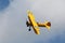 Yellow Stearman Airplane Flying Through the Air