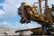 Yellow steel excavator in coal mine