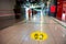 yellow sticker with a footprint in the mall recalls social distance during a pandemic