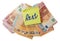 Yellow sticker with hand written sign rent on pile of Euro bank notes on white isolated background. Paying household bills concept