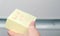 Yellow sticker paper sheet with words back at 12 in woman`s hand.