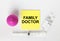 Yellow sticker with text Family Doctor on a white background with syringes, enema and ampoule