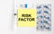 Yellow sticker with text Risk Factor on a white background with syringes, pills and ampoule