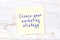 Yellow sticky note with handwritten text choose your marketing strategy