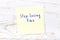 Yellow sticky note with handwritten text stop losing time