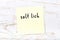 Yellow sticky note on wooden wall with handwritten word salt lick