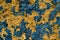 Yellow stone wall with dark blue paint pealing off/grunge wall t