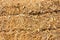 Yellow straw bales piled up in a field