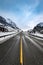 Yellow street marking in snowy winter landscape