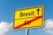 Yellow street sign with Brexit ahead leaving EU behind