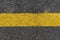 Yellow strip road markings on asphalt