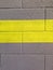 Yellow stripe on cinderblock wall