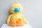 Yellow stuffed toy duck wearing a blue face mask