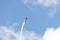 Yellow stunt plane climbing trailing a smoke contrail