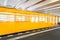 Yellow subway train in motion
