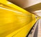 Yellow subway train speeding up on a city station. Business and