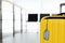 Yellow suitcase with label, space for text. Travel insurance