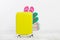 Yellow suitcase on white background Summer holidays. summer flip flops or slippers.Sandals beach.Travel valise or bag. Mo