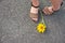 Yellow sunflower lying at the feet of a woman
