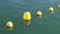 Yellow sunlit buoys in the water