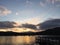 Yellow sunset over lake Windermere with a pier in the foreground