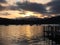 Yellow sunset over lake Windermere with a pier in the foreground