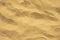 Yellow surface of aerial beach sand, loose sea sand dried under the scorching sun close-up texture background