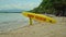 Yellow surfboard on beach with red text surf rescue emergency on a beach