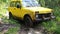 Yellow SUV got stuck in the mud in the forest, off-road