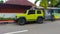 Yellow Suzuki Jimny parked on the side of the road