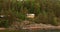 Yellow Swedish Wooden Sauna Log Cabin House On Island Coast In Summer Cloudy Day