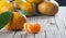 Yellow sweet isolated peeled and whole mandarin clementine tangerine on wooden rustic vintage table with leaf. Tangerines backgrou