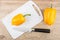 Yellow sweet peppers, cutting board and kitchen knife