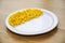 Yellow sweetcorn maize on a plate close up