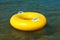 Yellow swim ring floating on a sea