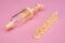 Yellow syringe for applying glaze on confectionery products on pink