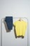 Yellow t-shirt and jeans displayed on clothes rack