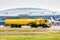 Yellow tank truck aircraft refueler at the airport apron