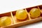 Yellow tasty grapes lie in wooden cells a box an isolated item on a white background
