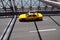 Yellow taxi on Brooklyn bridge