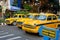 Yellow taxi cabs stopped at a pedestrian crossing