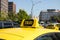 Yellow taxi car with a checker.