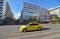 Yellow taxi and people waiting to cross the road at Syntagma Athens Greece