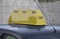 Yellow taxi roof sign with phone, money and credit cards on , closeup