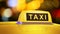 Yellow taxi sign on car