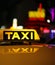 Yellow taxi sign on car roof