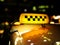 Yellow taxi sign checker at night