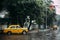 Yellow taxi with traffic jam on the road and waiting for green traffic light in the morning with rain at Kolkata, India